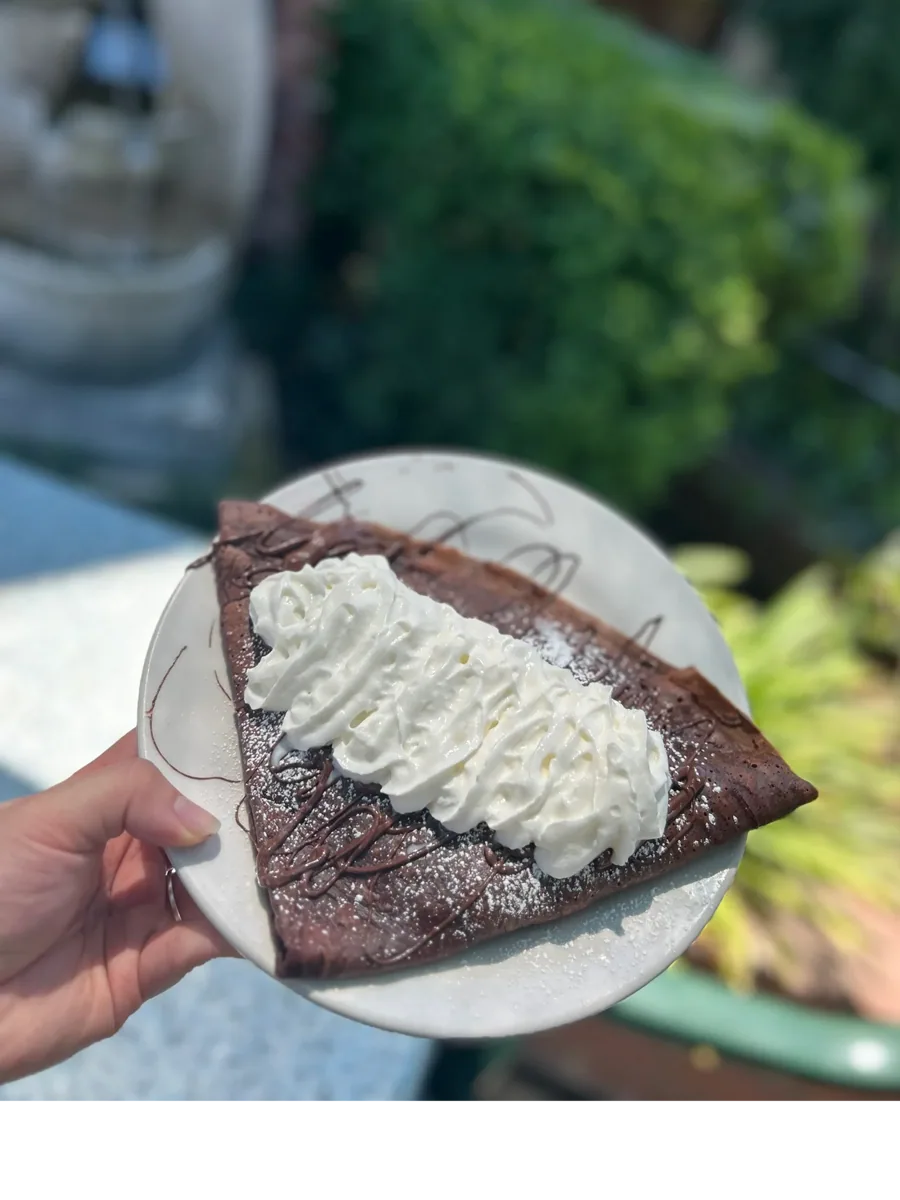Chocolate crêpe topped with whipped cream